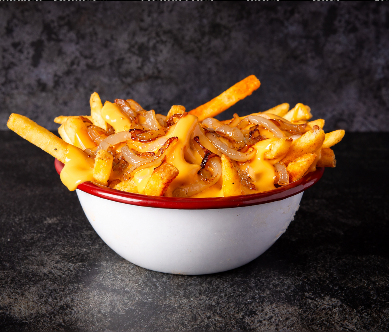 Close-up of cheesy fries with caramelised onions